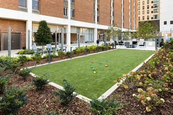 A grassy area with a bunch of balls in the middle of it